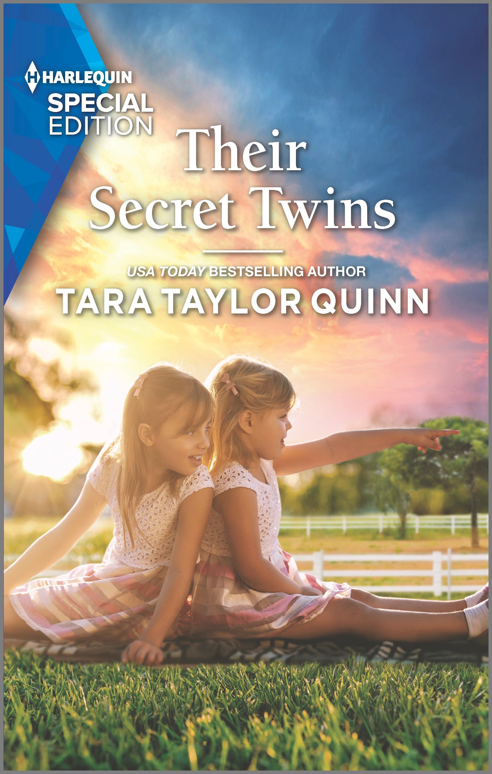 Cover image for THEIR SECRET TWINS by Tara Taylor Quinn, featuring two twin girls sitting in a field. One is pointing at something out of frame, and the other is looking where she is pointing with a smile on her face.